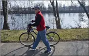  ?? BEN HASTY — MEDIANEWS GROUP ?? John Wolfe, a Schuylkill River Trail Ambassador on the trail with his bike. At Riverfront Park in Pottstown. The Schuylkill River Trail runs through the park.