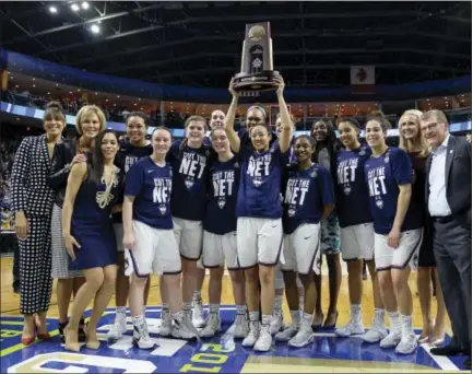  ?? JESSICA HILL — THE ASSOCIATED PRESS ?? UConn’s Saniya Chong holds the trophy as she poses with her teammates following their 90-52 win over Oregon in a Monday’s regional final in Bridgeport.