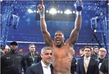  ?? RICHARD HEATHCOTE, GETTY IMAGES ?? Anthony Joshua, center, beat Wladimir Klitschko in 11 rounds Saturday to keep his IBF heavyweigh­t belt.