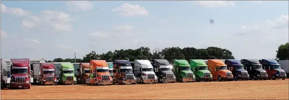  ?? Hunter McFerrin/Herald-Leader ?? A line of trucks sits idle during a cookout on Friday that was hosted by Hurricane Express for participan­ts going on the trip.