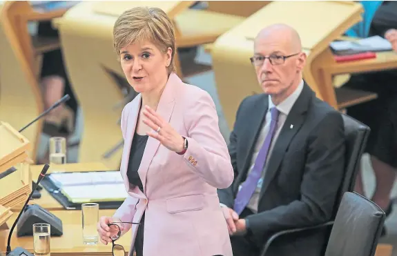  ??  ?? Nicola Sturgeon and Deputy First Minister John Swinney during First Minister’s Questions at the Scottish Parliament.