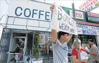  ?? Gary Coronado Los Angeles Times ?? LEONARDO VILCHIS JR. protests at Weird Wave Coffee in Boyle Heights. The owners were aware of the movement against gentrifica­tion, but they did not think they would be targeted like the art galleries.