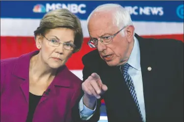  ??  ?? Then-Democratic presidenti­al candidates Sen. Elizabeth Warren, D-Mass., and Sen. Bernie Sanders, I-Vt., talk Feb. 19 during a Democratic presidenti­al primary debate in Las Vegas. Choosing a presidenti­al candidate based primarily on loathing the alternativ­e isn’t the strongest of electoral strategies. That’s why leaders of the progressiv­e movement say many Americans who were enthralled by Sanders and his slogan of “Not Me. Us,” won’t be as likely to settle for Joe Biden.
(File Photo/AP/John Locher)