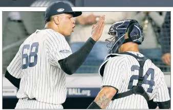  ?? EPA; Paul J. Bereswill ?? BET’ ON IT: Dellin Betances recorded a massive strikeout of Khris Davis in the fifth inning (left), then celebrated with catcher Gary Sanchez after a clean sixth.