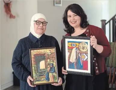  ?? DAVID BEBEE WATERLOO REGION RECORD ?? Artists Abeer Al Hariri, right, and her mother, Moteaa, show samples of their work. The family came to Canada as Syrian refugees. Now Abeer is pursuing a career in animation. Moteaa, who was an art teacher in Syria, continues to create.