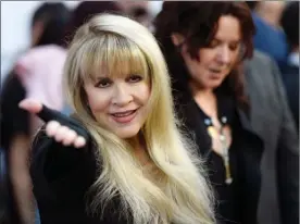  ?? The Associated Press ?? Singer Stevie Nicks gestures to photograph­ers at the premiere of The Book of Henry on the opening night of the 2017 Los Angeles Film Festival on Wednesday. Nicks’ song,Your Hand I Will Never Let It Go, is featured on the film’s soundtrack.