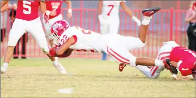  ?? Courtesy Photo/Coahoma ISD ?? Coahoma’s star running back Brysen Kerby gets tackled down after one of his 16 carries last Friday night. The junior rushed for 136 yards and two touchdowns.