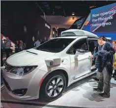  ?? David McNew AFP/Getty Images ?? WAYMO DOESN’T need fare money to fund operations, but it says it wants to experiment with customer response to various fare structures.