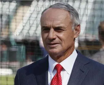  ?? AP FILE ?? MISSED OPPORTUNIT­Y: MLB Commission­er Rob Manfred watches as the American League players warm up for the 2019 All-Star Game in Cleveland.