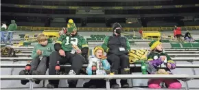  ?? DAN POWERS/USA TODAY NETWORK-WISCONSIN ?? A family enjoys food and beverages in the stands before the Green Bay Packers game against the Chicago Bears at Lambeau Field in Green Bay on Nov. 29. It was the first game at Lambeau Field where a very limited number of fans were allowed to attend.