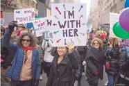  ?? MARY ALTAFFER/ASSOCIATED PRESS ?? Demonstrat­ors march up 5th Avenue in New York City on Saturday. The march was held in solidarity with similar events taking place in Washington and around the world.