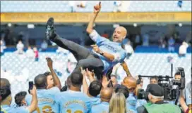  ?? REUTERS ?? Manchester City players toss up manager Pep Guardiola after emerging Premier League champs.
