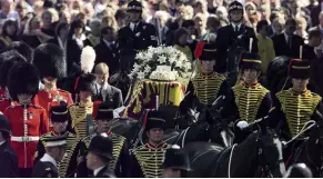  ?? PHOTO: REUTERS ?? Prince William watches as his mother Diana, Princess of Wales is carried to Westminste­r Abbey for her funeral, in London in 1997.