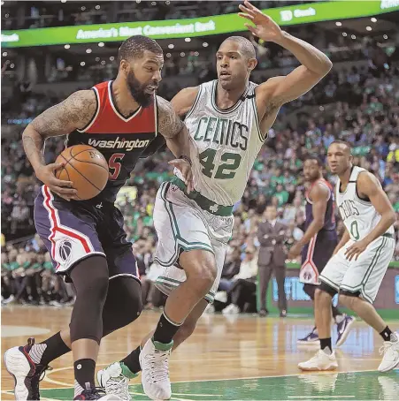  ?? STAFF PHOTO By MATT STONE ?? STOP IT: Al Horford defends against Washington’s Markieff Morris during the first half of the Celtics’ Game 5 win over the Wizards last night at the Garden.