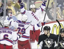  ?? ASSOCIATED PRESS ?? The Rangers’ Brian Boyle (center) celebrates his goal to open the scoring in Tuesday night’s Game 7. Brad Richards also scored to help NewYork win 2-1.