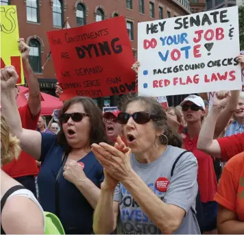  ?? ANGELA ROWLINGS PHOTOS / HERALD STAFF ?? STOP THE SHOOTING: Demonstrat­ors gather on City Hall Plaza to demand legislatio­n to require background checks on all gun sales on Sunday in Boston. Top left, Angela Christiana, local chapter leader of Moms Demand Action for Gun Sense, speaks during the demonstrat­ion.