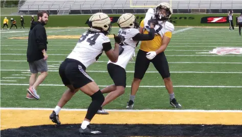  ?? (Pine Bluff Commercial/Tanner Spearman) ?? UAPB tight ends run a drill during an April 6 football practice as tight ends coach Chris Forestier looks on.