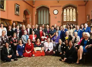  ?? — AP ?? We’ve come a long way: New Zealand women lawmakers, with Ardern in the centre holding baby Neve, posing for a photograph at Parliament in Wellington. They were re-enacting a 1905 photograph (right), which featured only male lawmakers.