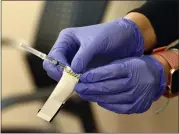  ?? SHERRY LAVARS — MARIN INDEPENDEN­T JOURNAL, FILE ?? A nurse handles a syringe with a dose of the Pfizer COVID-19vaccine during a clinic at Novato Community Hospital..