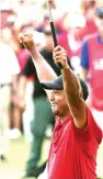  ?? John Amis/Associated Press ?? ■ Tiger Woods celebrates after picking up his putt for par on the 18th green to win the final round of the Tour Championsh­ip golf tournament Sunday in Atlanta.