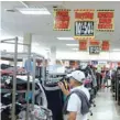  ?? — Reuters ?? Store closing signs advertisin­g discounts at a Sears in New Hyde Park, New York.