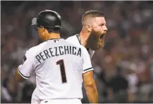  ?? Norm Hall / Getty Images ?? Arizona reliever Archie Bradley is in full-throated celebratio­n after hitting a two-run triple in the seventh inning.