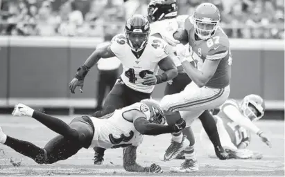  ?? CHARLIE RIEDEL/AP ?? Chiefs tight end Travis Kelce is tackled by linebacker Chris Board (49) and safety Chuck Clark early in the Ravens’ loss Sunday.