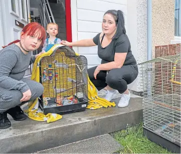  ??  ?? MISSING: Grace, 9, Jack, 1, and mum Laura with the empty cage. Pictures by Steve Brown.