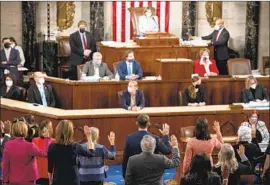  ?? Bill Clark Pool Photo ?? HOUSE SPEAKER Nancy Pelosi ( D- San Franscisco) administer­s the oath of off ice to members of the 117th Congress at the Capitol in Washington on Jan. 3.