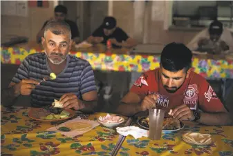  ??  ?? River Ranch is one of three housing centers for workers supported by a self-imposed fee on Napa Valley vineyard owners. Ruben Montoya (left) and his son, Ivan Montoya, enjoy a buffet-style dinner in the cafeteria of River Ranch, which offers clean,...