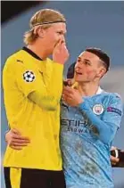  ?? AFP PIC ?? Man City’s Phil Foden (right) walks off the pitch with Dortmund’s Erling Braut Haaland after their Champions League match on Tuesday.