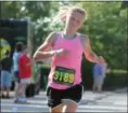  ?? RANDY MEYERS — THE MORNING JOURNAL ?? Women’s winner Savannah Dennison, of Mentor, strides across the finish line on July 30.