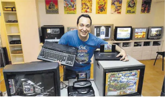  ?? Anna Mas Talens ?? Carles Garcia, con algunos tesoros de su colección. En su mano derecha, un MSX 2; en la izquierda, el Rolls-Royce de las consolas: la Neo Geo AES.