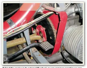  ??  ?? Behind the engine is its external flflflywhe­el, as was common practice on cars at the time, and the somewhat indelicate coupling for the drive shaft. The teeth on outside of the flywheel are for the starter motor to grip