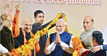  ?? — AP ?? Prime Minister Narendra Modi is being felicitate­d by senior party leaders — finance minister Arun Jaitley, party chief Amit Shah, home minister Rajnath Singh and external affairs minister Sushma Swaraj — at the party headquarte­rs in New Delhi on Monday...