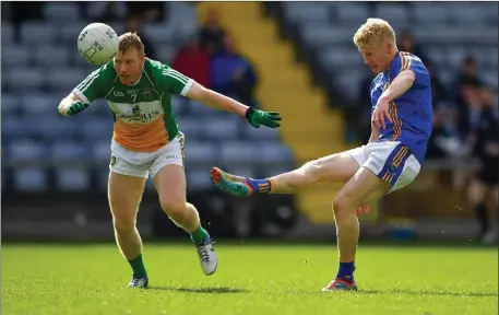  ??  ?? Wicklow’s Mark Kenny gets his shot away as Offaly’s Niall Darby closes in.