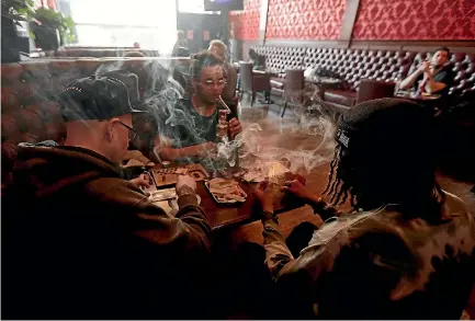  ?? PHOTO: AP ?? Customers, clockwise from from left, Rick Thompson, Keith Baskervill­e and Xavier Baskervill­e smoke marijuana while sitting in a booth in the smoking lounge at the Barbary Coast Collective cannabis bar and smoking lounge in San Francisco.