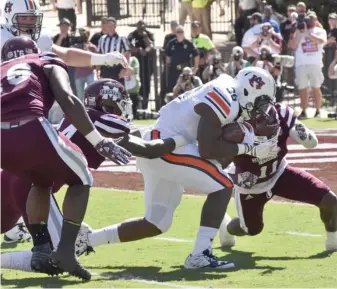  ?? (Photo by Jason Cleveland, SDN) ?? Auburn running back Kamryn Pettway (36) run all over the Mississipp­i State defense last season.