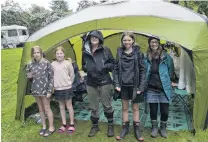  ??  ?? Roughing it with smiles . . . Staying dry in their tent at the folk festival on Saturday are (from left) Asheika (12), Katiya (10) and Meg Brasell, Rosa Fyfe (11) and Rebecca South.