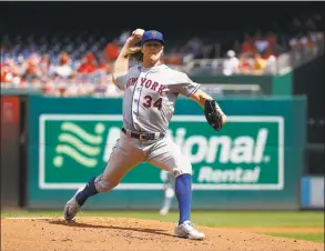  ?? Patrick Semansky / Associated Press ?? New York Mets starting pitcher Noah Syndergaar­d throws to the Washington Nationals during a game on Sept. 2.