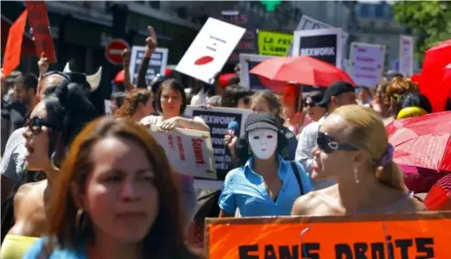  ?? ?? A French sex worker holds a banner reading "Without rights" at a march in Paris, 2 June, 2011