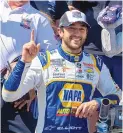  ?? JASON MINTO/ASSOCIATED PRESS ?? Chase Elliott gestures next to his trophy after winning Monday’s weatherdel­ated NASCAR Cup race at Dover Motor Speedway. It was his first victory of the season.