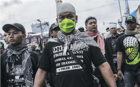  ?? ULET IFANSASTI/GETTY IMAGES FILES ?? Anti-LGBT activists protest in Yogyakarta, Indonesia, in February. Increasing­ly, it is companies’ chief executives instead of politician­s who are faced with protecting the rights, and lives, of LGBT employees. But few companies are willing to discuss...