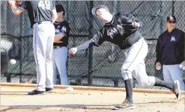  ?? CHARLES TRAINOR JR. / MIAMI HERALD ?? Marlins reliever Brad Ziegler, the second-oldest player on the roster at 37, shows offff unorthodox submarine delivery during a workout. his