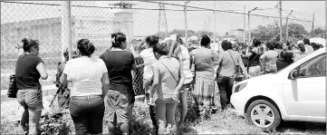  ??  ?? Relatives and friends of inmates stand outside a prison after a riot broke out at the maximum security wing in Acapulco, Mexico. — Reuters photo