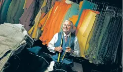  ?? OSEPH VICTOR STEFANCHIK/WASHINGTON POST FILE PHOTO ?? Martin Greenfield, who tailored garments for presidents, entertaine­rs, artists, athletes and others, poses near fabrics at his workspace in 2012. Greenfield died Wednesday at a hospital in Manhasset, N.Y. He was 95.