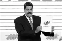  ?? ASSOCIATED PRESS ?? IN THIS MAY 22 FILE PHOTO, Venezuela’s President Nicolas Maduro holds up the National Electoral Council certificat­e declaring him the winner of the presidenti­al election during a ceremony at CNE headquarte­rs in Caracas.