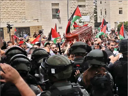  ?? Photo: Nampa/AFP ?? Attack… Israeli security forces attack Palestinia­n mourners carrying the coffin of slain Al-Jazeera journalist Shireen Abu Akleh out of a hospital on 13 May 2022.