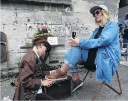  ??  ?? On the job . . . Elliot Mackenzie shines the shoes of Hannah Denny.