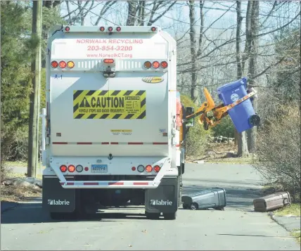  ?? Hearst Connecticu­t Media file photo ?? A City Carting truck making the rounds in 2017 in Norwalk. The city has yet to join the new Connecticu­t Coalition for Sustainabl­e Materials Management, through which about half the state’s municipali­ties are weighing strategies to reduce waste including charging households and businesses for the amount of trash they actually produce, rather than a flat-fee for curbside pickup.